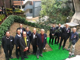 Distinguished alumni and guests witnessing the planting of the oak tree