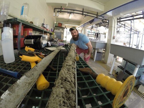 Cybulski looking down the “fossil time machine” containing coral fossils for analysis. (Photo credit: Dr Kiho Kim)