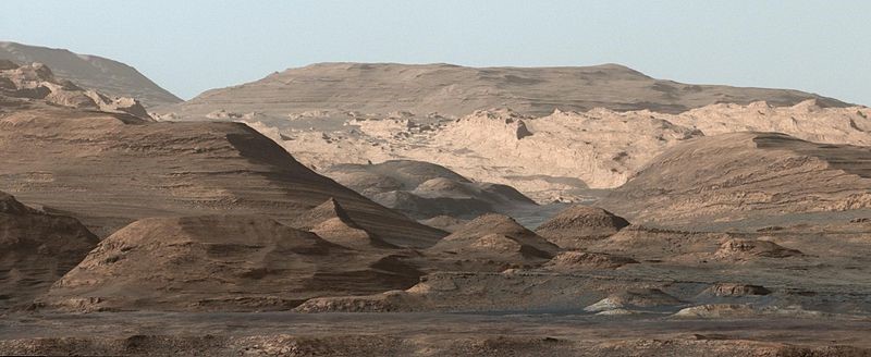 Image 1: An image taken by the Curiosity Rover MastCam  instrument shows layered sedimentary rocks composing Mount Sharp. The rover has been driving from the floor of Gale crater up through the rocks within these hills in order to understand how the rocks