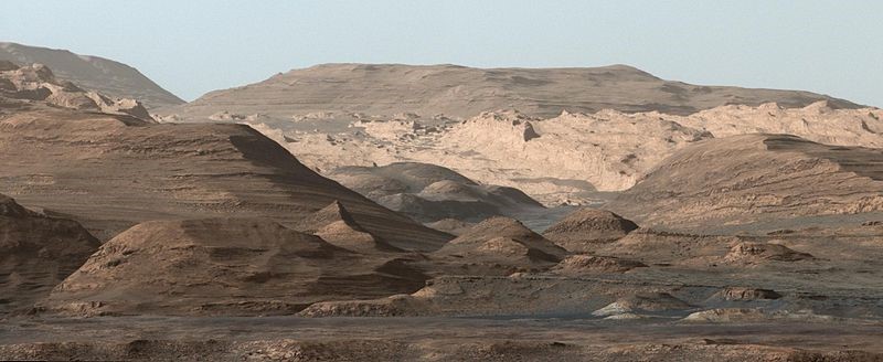 Image 1: An image taken by the Curiosity Rover MastCam  instrument shows layered sedimentary rocks composing Mount Sharp. The rover has been driving from the floor of Gale crater up through the rocks within these hills in order to understand how the rocks